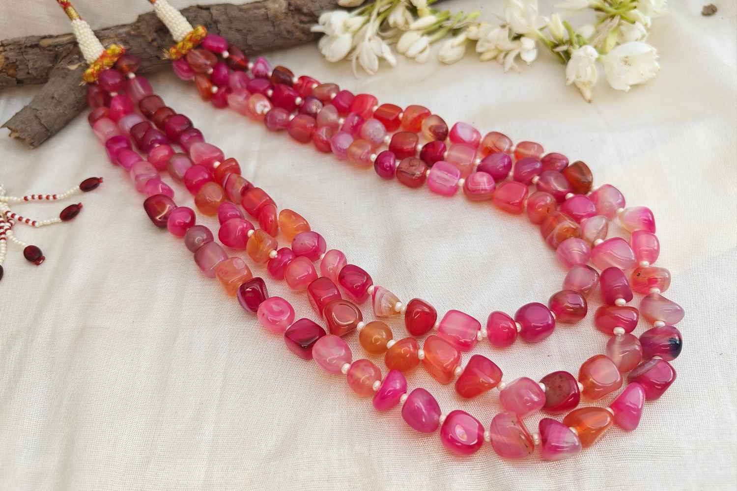 Bead Mala made of dark pink rhodonite stones, showcasing vibrant energy and emotional balance, elegantly layered design.