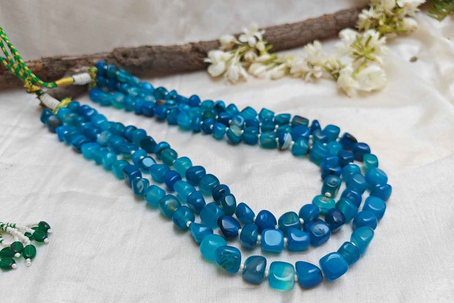 Bead Mala made of light blue aquamarine stones, showcasing multi-layered design for serenity and style.