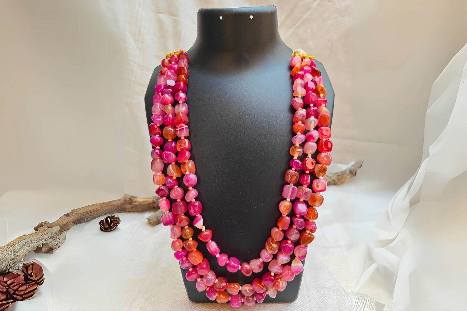 Bead Mala showcasing dark pink rhodonite stones in a vibrant layered design for emotional balance and courage.