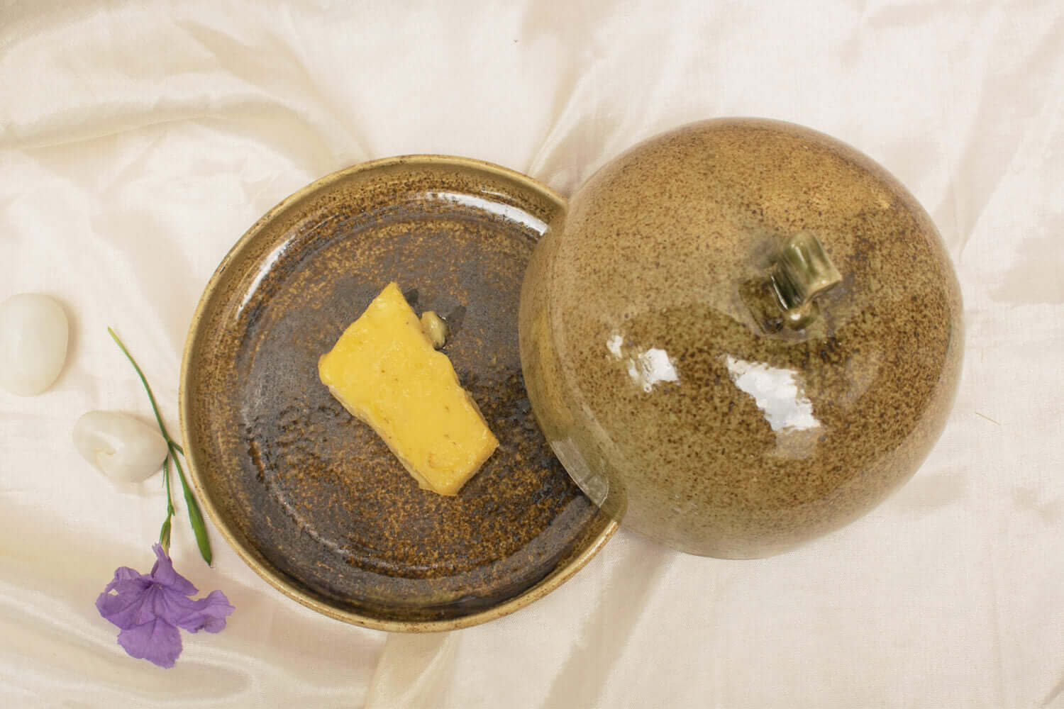 rustic butter dish on kitchen counter with butter inside